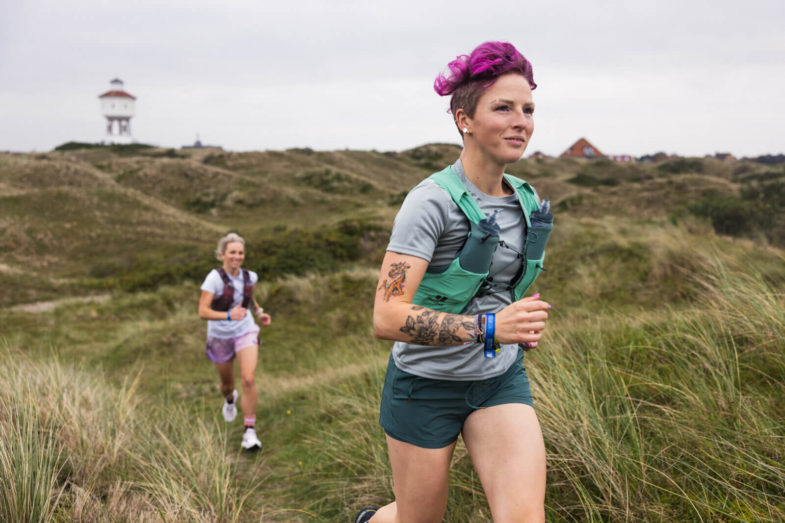 Two women running in deuter vest and new Hydrapak hydration system.
